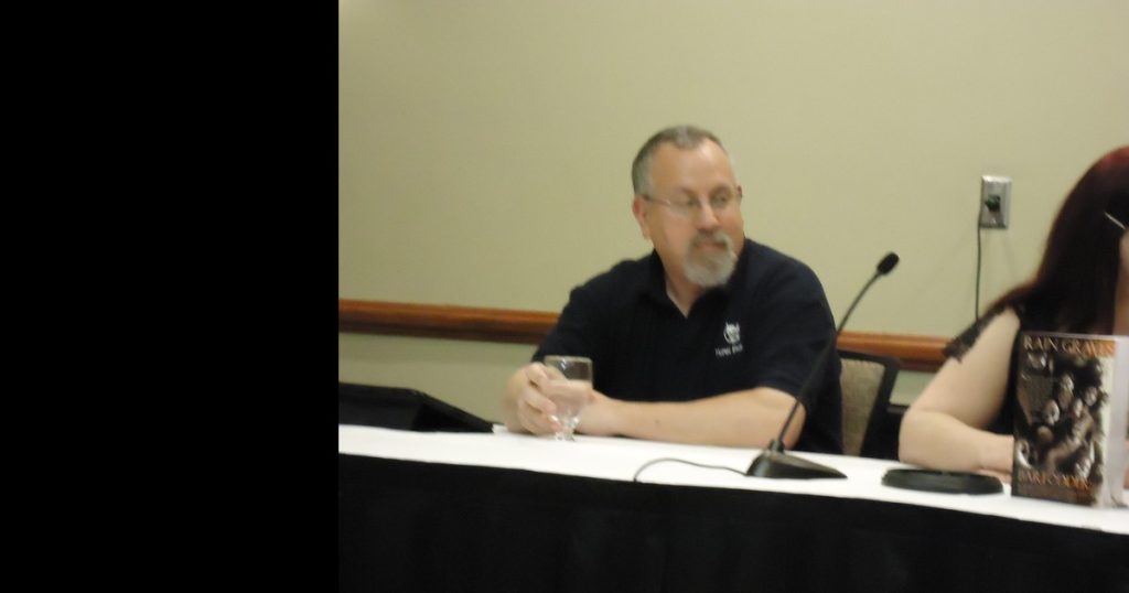 Guy Anthony De Marco on a panel at the 2012 World Horror Convention, seated at a table with a microphone in a Yurei Press polo.
